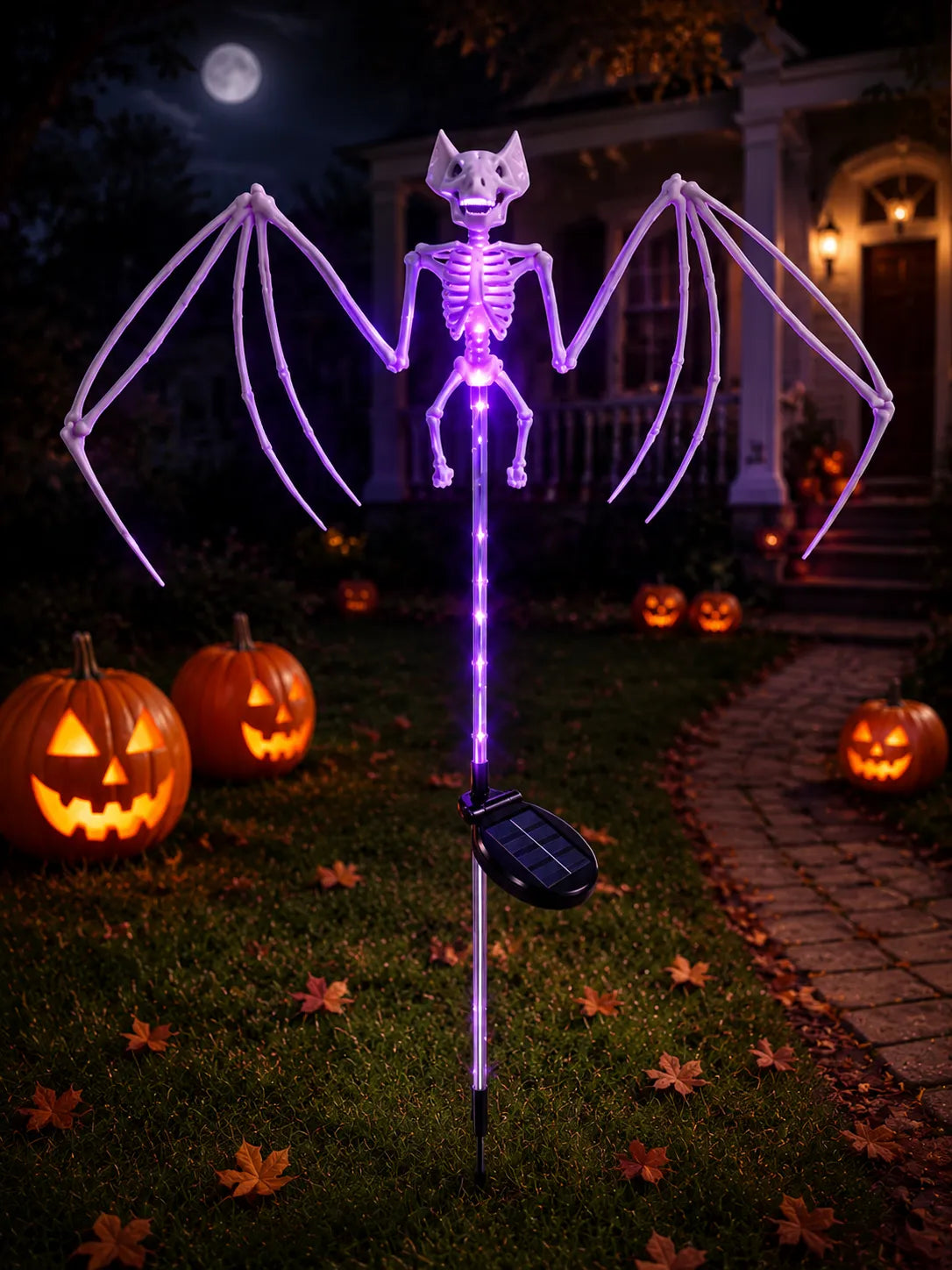 Purple Solar Bat Skeleton Garden Stake Light in a Halloween yard