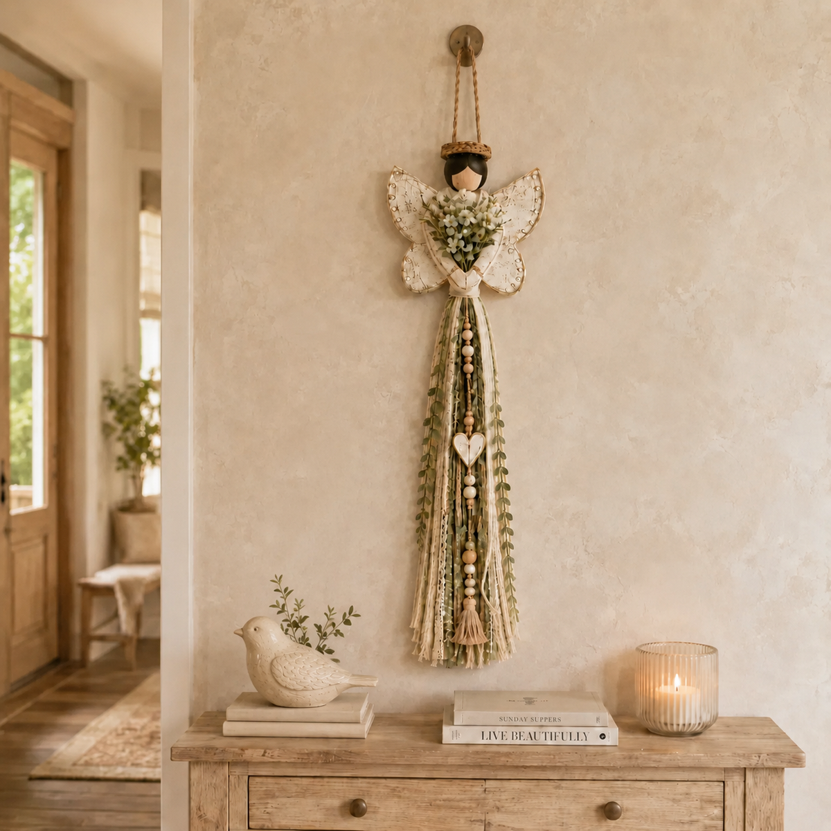 Grace In Bloom angel wall hanging displayed above a warm wood console