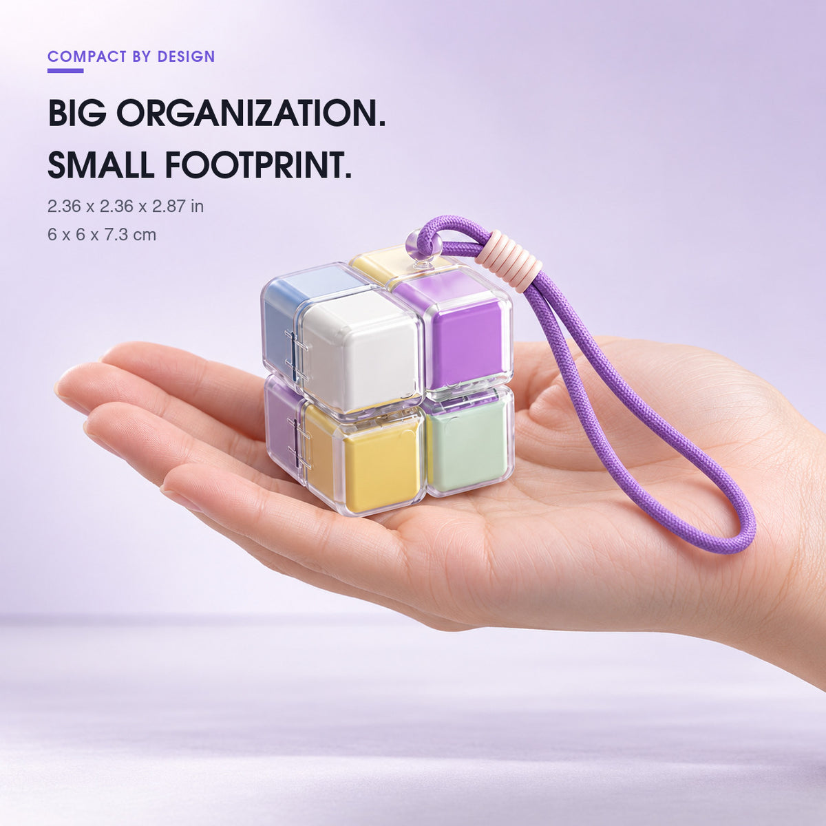 Compact rotating cube pill organizer shown in a person's hand with dimensions