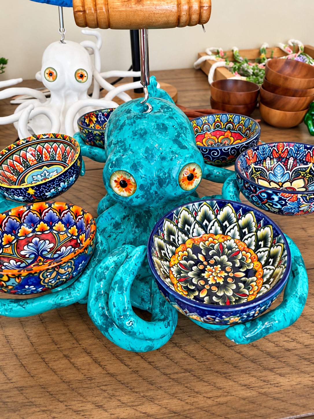 Six colorful serving bowls around octopus sculpture