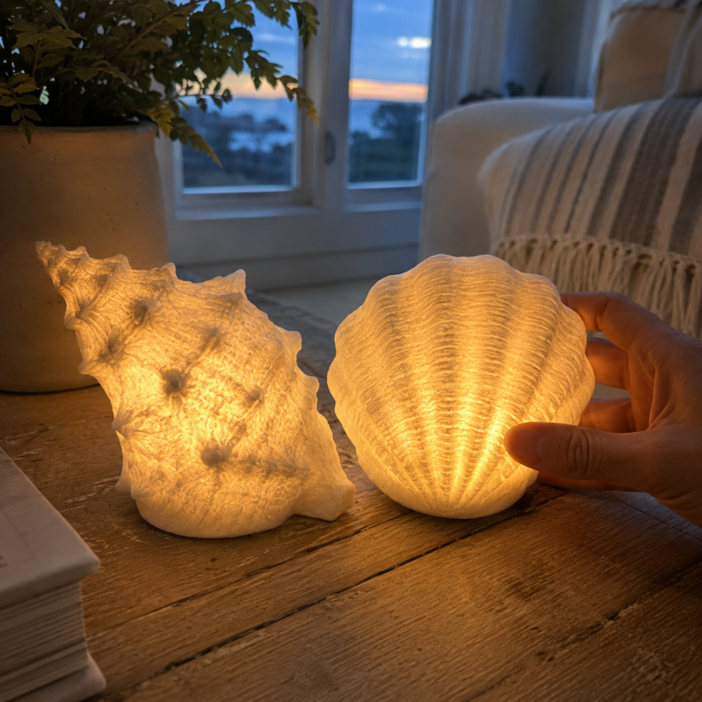 Hand touching glowing seashell lamp