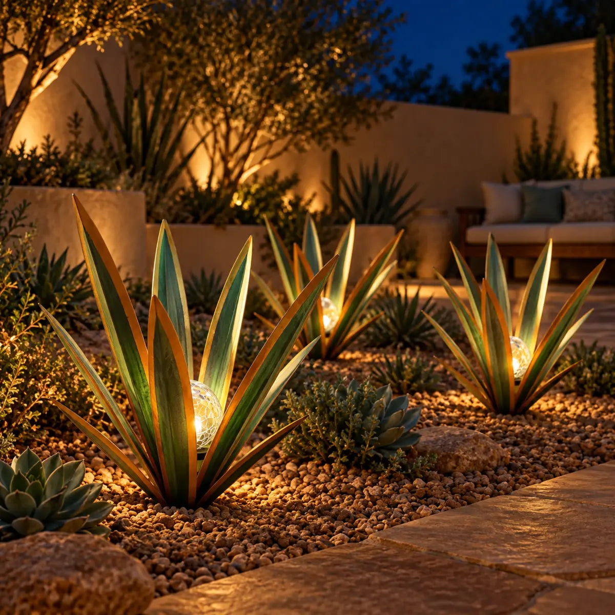 Customer-style photo of agave lights beside a patio border at night