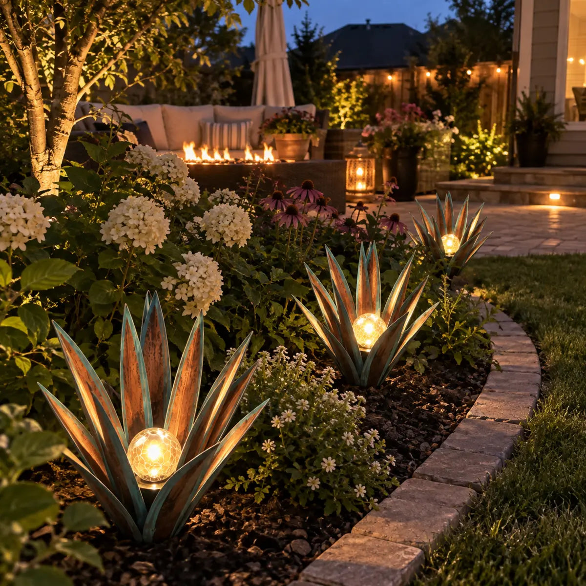 Customer-style evening garden display with several agave lights
