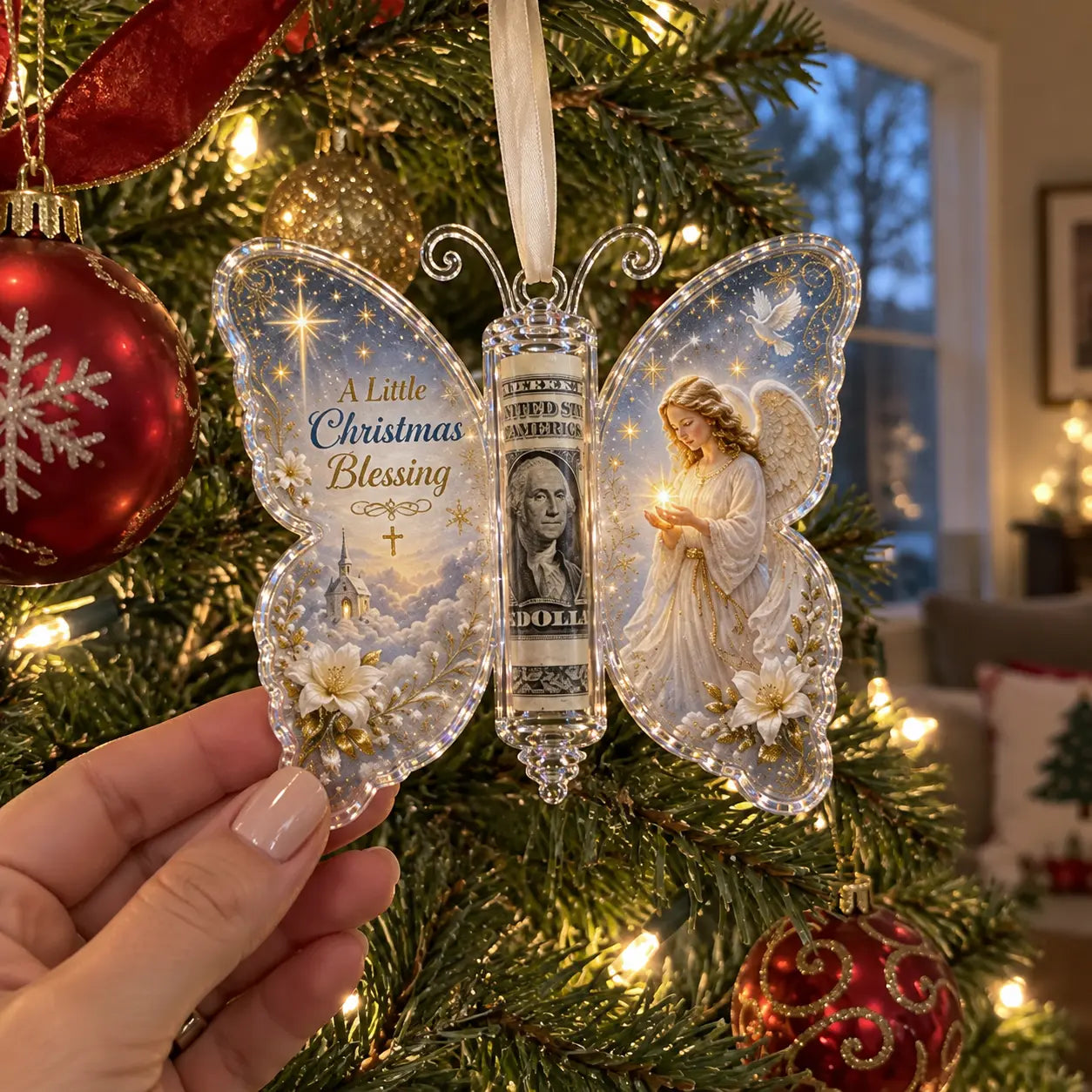 Angel-themed butterfly money ornament held beside a Christmas tree