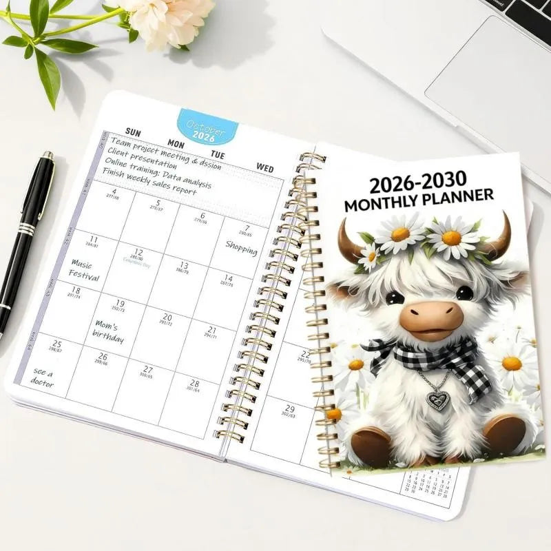 Highland Cow five year planner open on desk