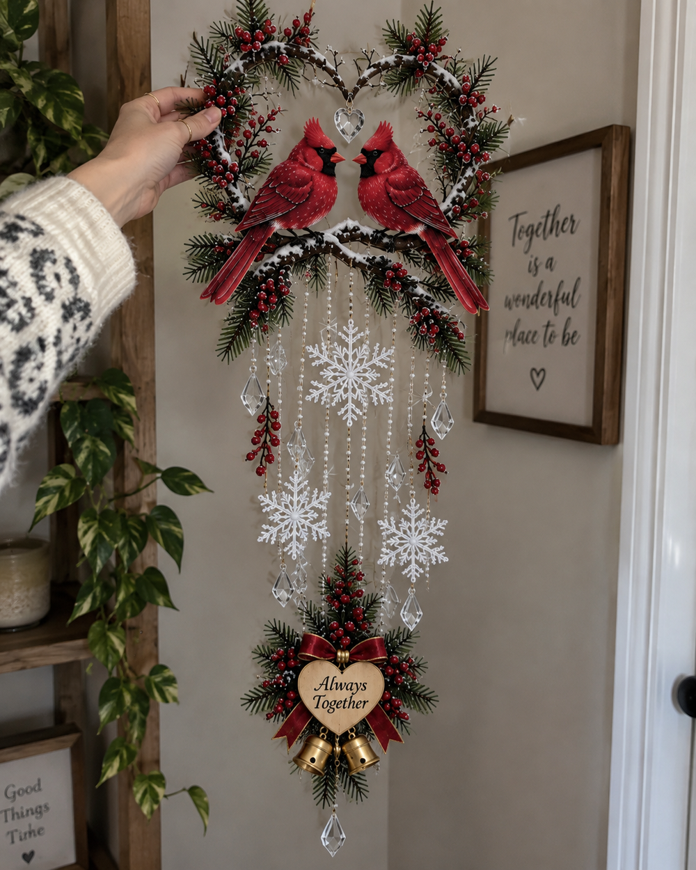 Cardinal Christmas wall light being adjusted by hand