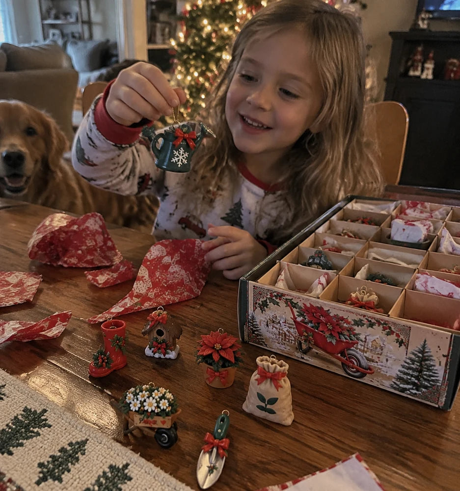 Child opening a gardening Christmas ornament surprise