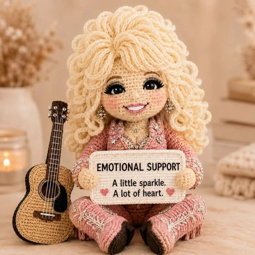 Country music comfort doll holding an emotional support message sign with mini guitar