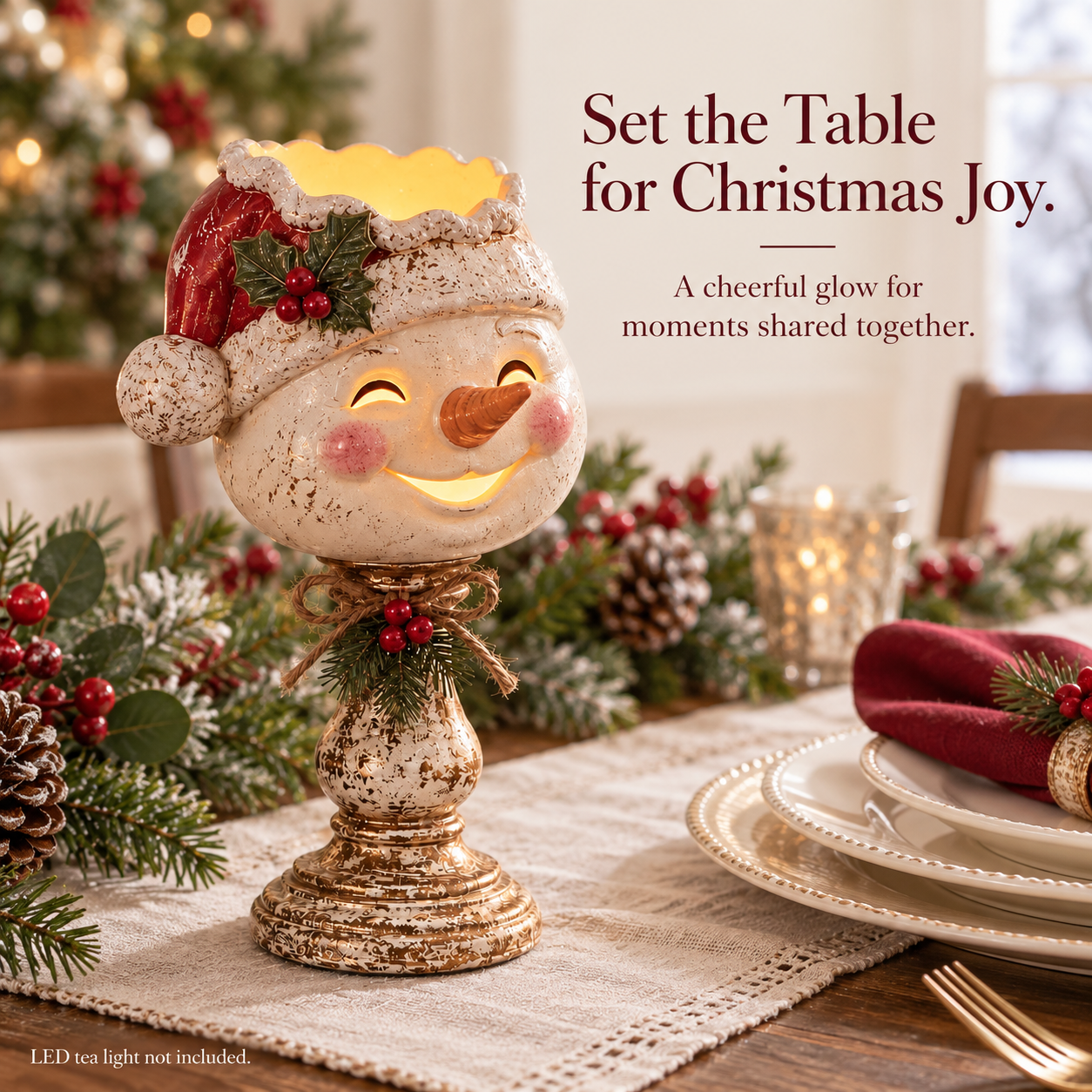 Snowman candle holder displayed beside a Christmas table setting