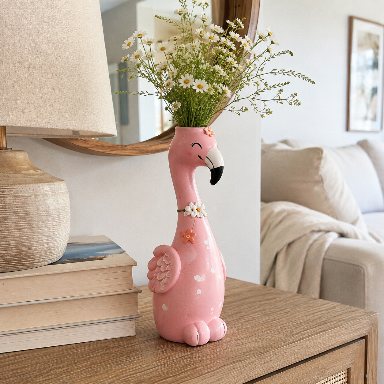 Flower-accent flamingo vase displayed on a wooden console