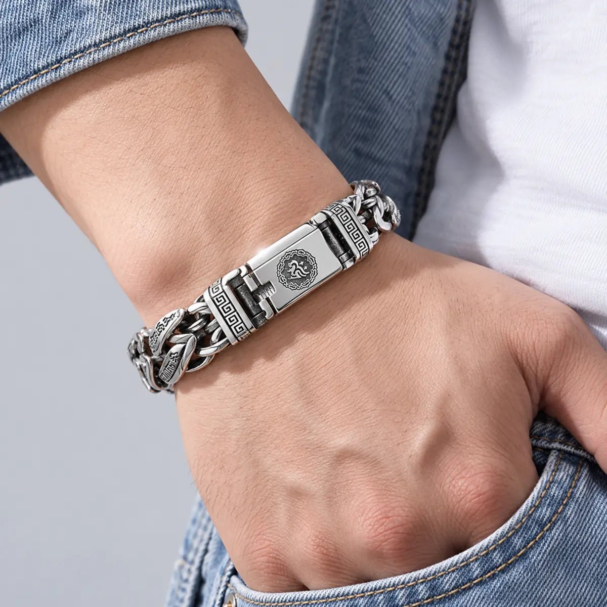 Antiqued silver-tone engraved chain bracelet worn on the wrist