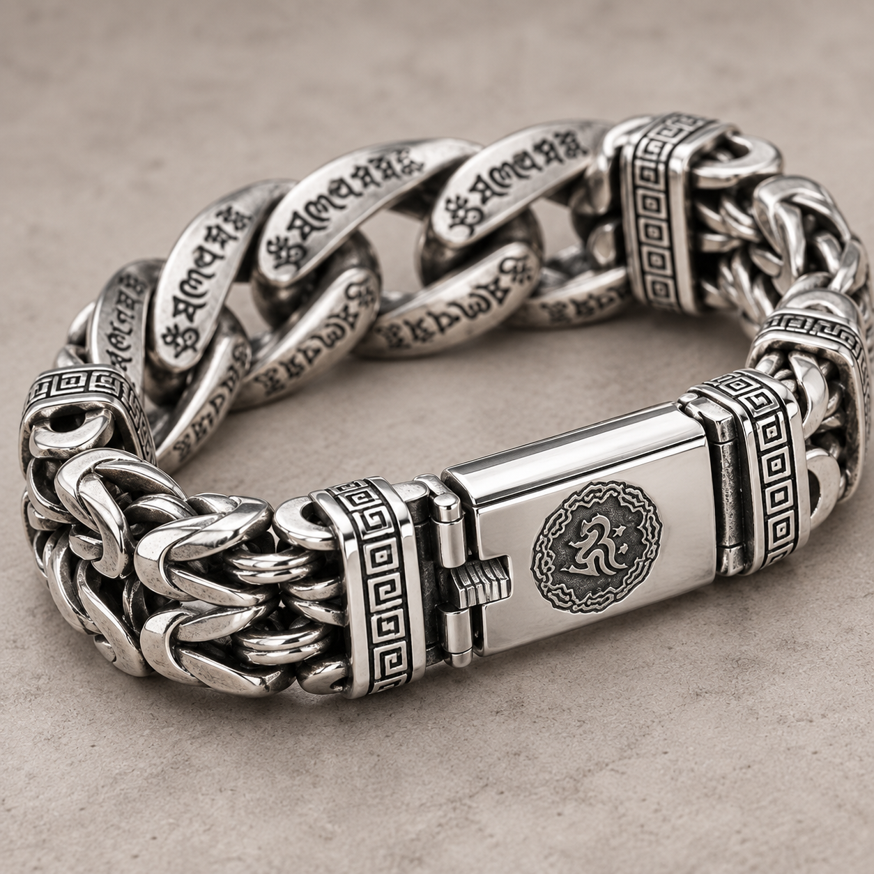 Silver-tone engraved bracelet arranged on natural stone