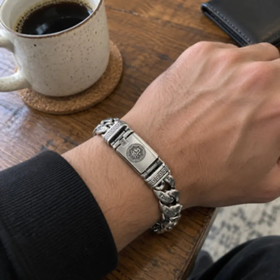 Customer wearing the engraved bracelet beside a cup of coffee