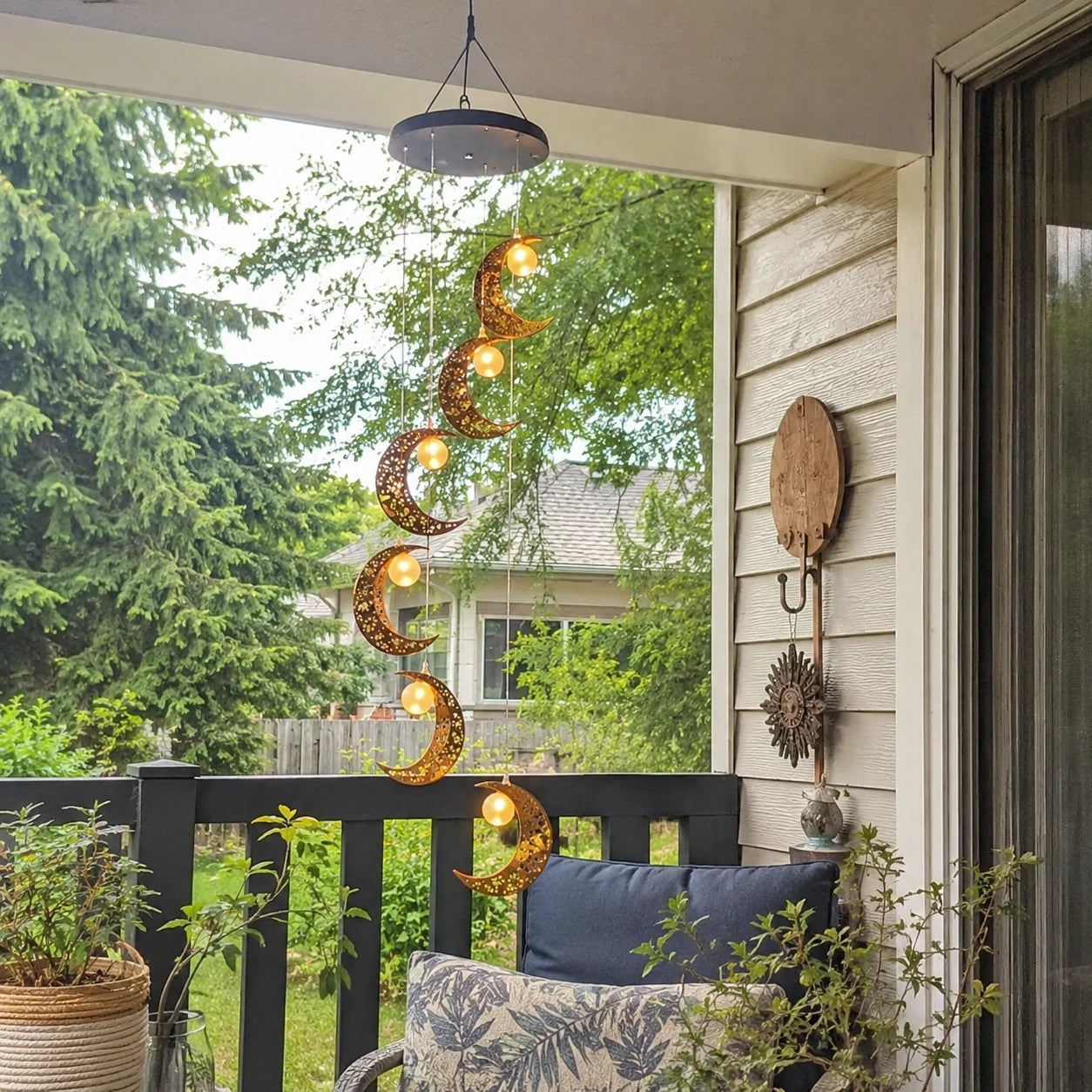 Customer photo of moon wind chime hanging on porch during the day