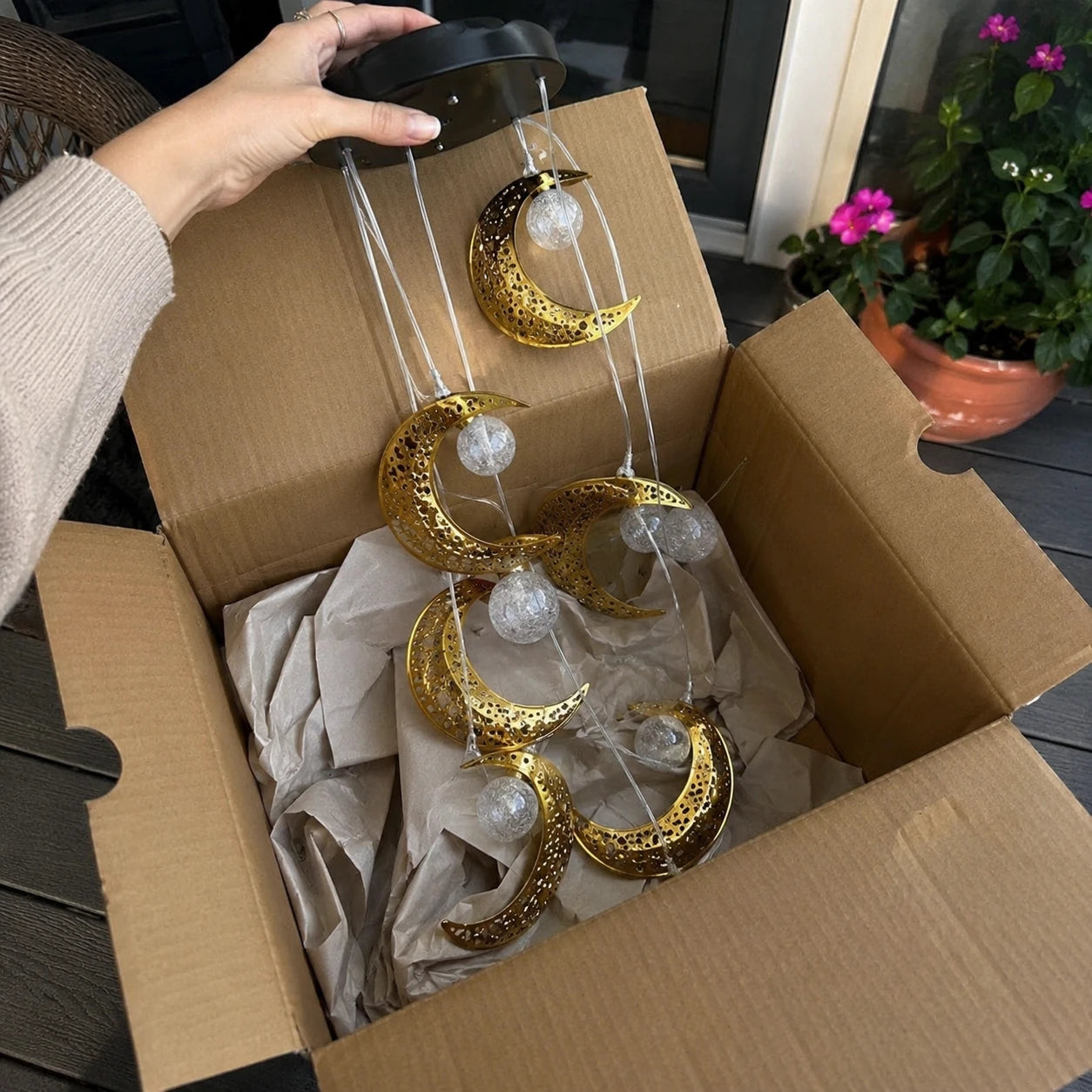 Customer unboxing the moon wind chime
