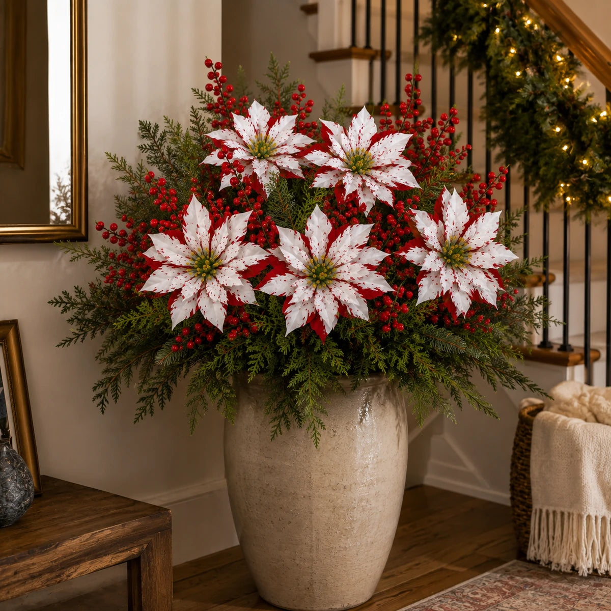 Christmas poinsettia floral picks arranged in a large indoor vase