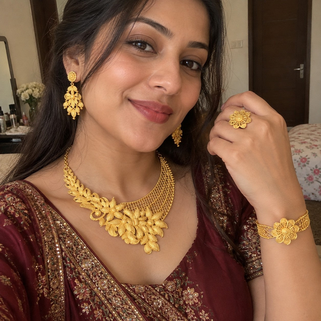 Customer wearing the gold jewelry set in a selfie