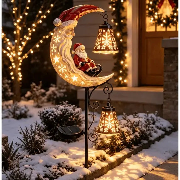 Santa Moonlight Lantern garden stake glowing in a snowy garden