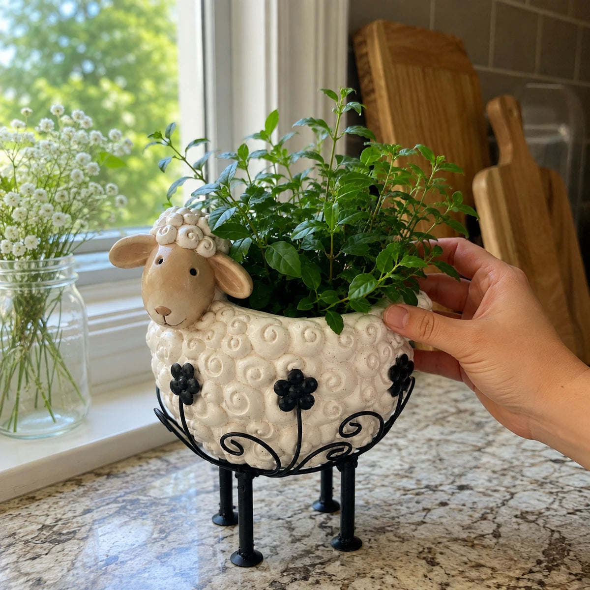 Sample review image with a person's hand styling greenery in the sheep planter