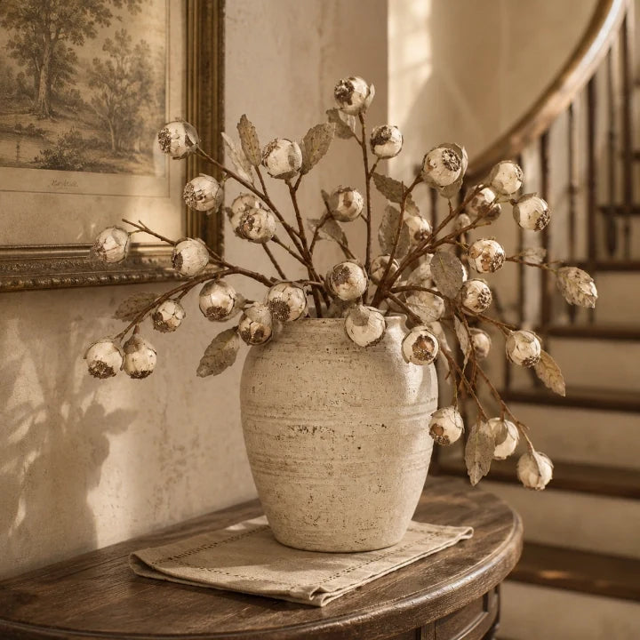 Antique cream faux thistle berry stems in a vintage home interior