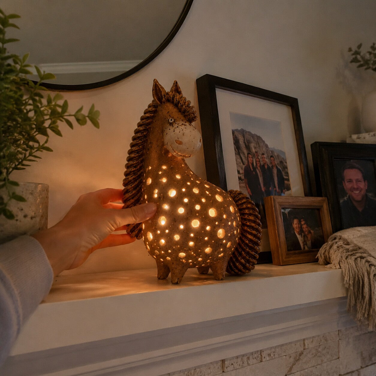 Customer styling the glowing horse light on a family mantel